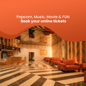 Interior view of a modern movie theater lobby with comfortable seating and ticket counters.