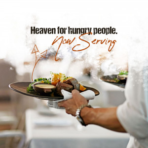 A waiter serving a plate of food in a restaurant.