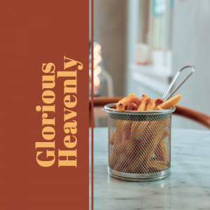 Close-up of a small metal basket filled with golden french fries, with text overlay 'Glorious Heavenly'