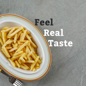 A plate of golden, crispy french fries with text 'Feel Real Taste'