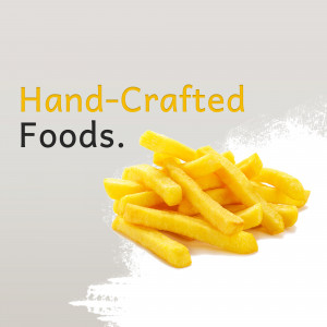 Close-up of golden, hand-cut French fries with text overlay 'Hand-Crafted Foods.'