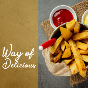 Close-up of golden french fries in a metal basket with ketchup