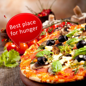 Close-up of a delicious pizza with fresh toppings and a 'Best place for hunger' speech bubble.