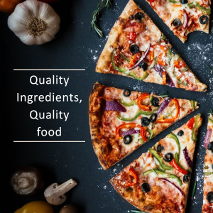 Close-up of a pizza with colorful toppings and fresh garlic and mushrooms