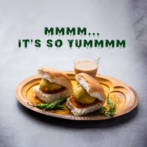 Close-up of Vada Pav with a glass of tea