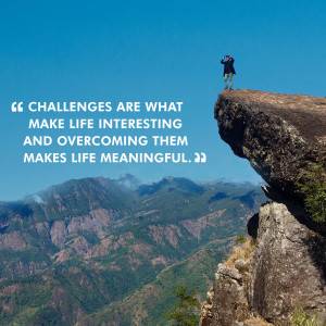 Person standing on a cliff overlooking mountains with an inspirational quote.