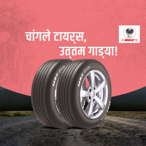 Two MRF tyres stacked against a road background with text in Marathi.