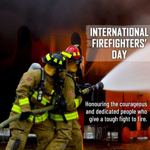 Three firefighters in action, spraying water on a fire.