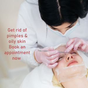Close-up of a dermatologist performing a blackhead extraction on a female patient.