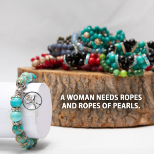 Close-up of a variety of colorful beaded bracelets on a wooden surface with a wrist display.