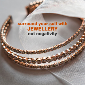 Close-up of a rose gold bracelet with diamonds and text 'surround your self with JEWELLERY not negativity'