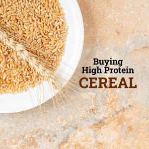 A white plate filled with wheat kernels and a sprig of wheat, with text overlay 'Buying High Protein CEREAL'