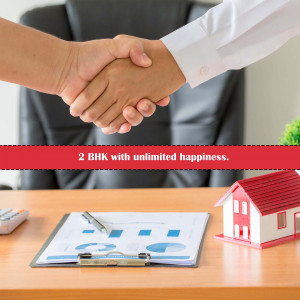 Handshake over a real estate contract and house model