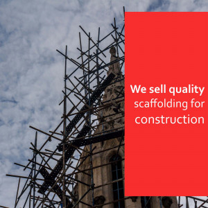 Scaffolding around a church tower with text advertising scaffolding sales
