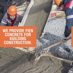 Construction workers pouring concrete for building foundation.