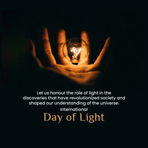 Hand holding a glowing lightbulb with text 'Day of Light'