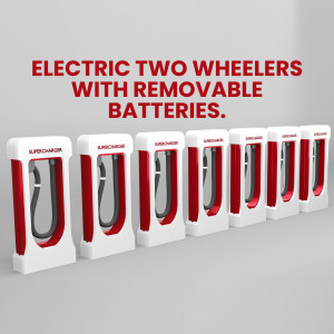 Row of red and white electric two-wheeler charging stations with removable batteries.