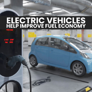 A blue electric car charging at a charging station in a parking garage.