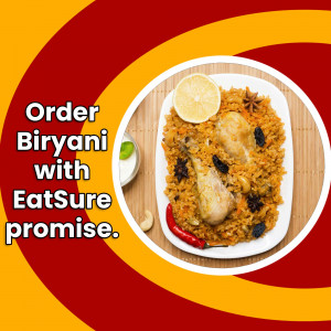 A plate of Biryani with lemon wedge and spices, promoting EatSure delivery.