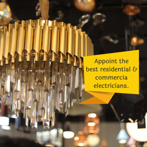 Close-up of a golden chandelier with a yellow advertisement banner.