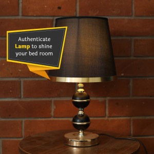 A black and gold bedside lamp with a speech bubble promoting 'Authenticate Lamp to shine your bed room'