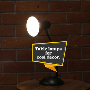 Black table lamp illuminating a sign that reads 'Table lamps for cool decor' against a brick wall.