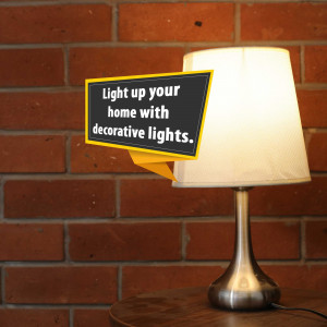 A table lamp with a chalkboard sign promoting decorative lights.
