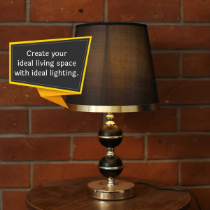 A black table lamp with a gold base and a speech bubble promoting ideal lighting.