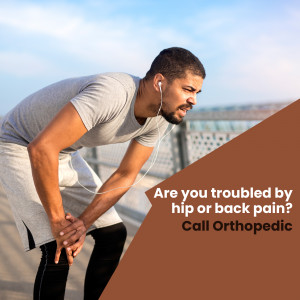 Man experiencing hip and back pain while exercising