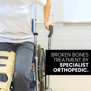 Patient in a wheelchair with a leg cast receiving orthopedic care.