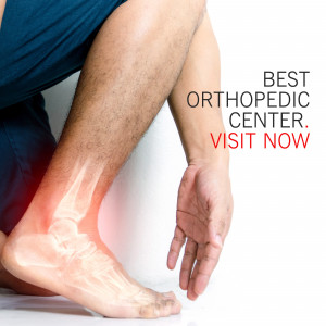 Man holding his injured ankle, promoting an orthopedic center.