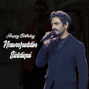 Nawazuddin Siddiqui holding a microphone with a birthday greeting