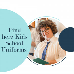 A student in school uniform smiling and holding a book.