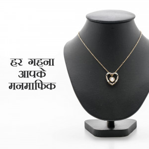 Gold heart pendant necklace on a black display bust