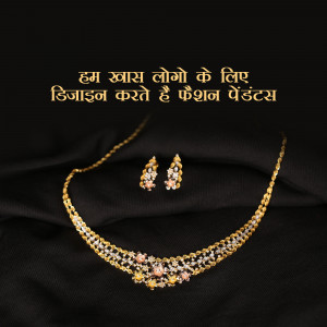 Close-up of a gold necklace and earring set on a black fabric background.