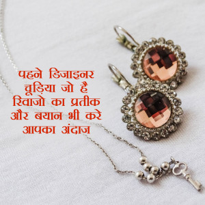 Close-up of a silver necklace and earrings with red and clear gemstones.