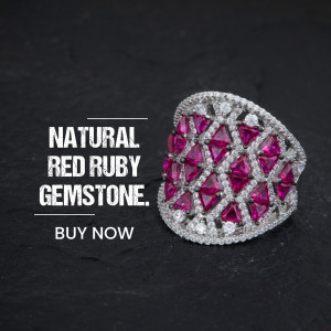 Close-up of a silver ring with a natural red ruby gemstone.