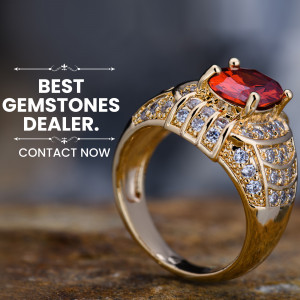 Close-up of a luxurious gold ring with a large red gemstone.
