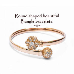 Close-up of a rose gold bangle bracelet with floral and beaded details.