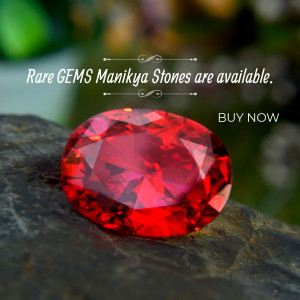 Close-up of a vibrant red Manikya stone on a rocky surface with text promoting availability and a 'Buy Now' call to action.