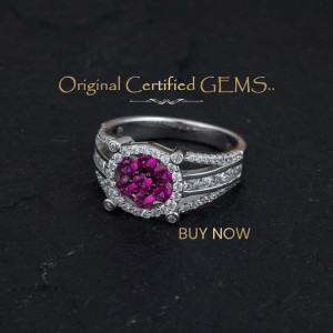 Close-up of a silver ring with a cluster of rubies and surrounding diamonds.
