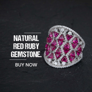 Close-up of a silver ring with a row of vibrant red rubies and sparkling diamonds.