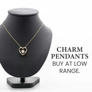 Gold heart charm pendant necklace on a black mannequin