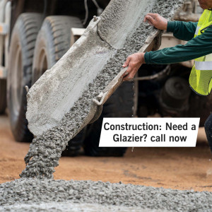 Concrete being poured from a mixer truck at a construction site.