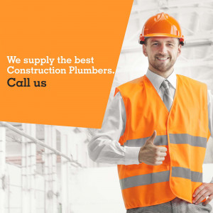 Construction plumber wearing a hard hat and safety vest giving a thumbs up