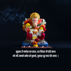 Image of Lord Ganesha decorated with flowers and surrounded by lit diyas