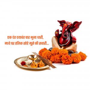A beautiful statue of Lord Ganesha surrounded by marigold flowers and traditional sweets.