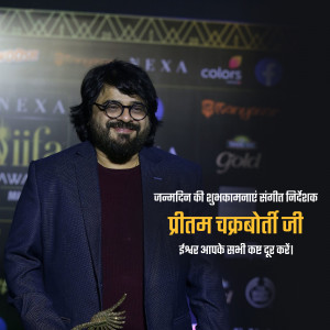 Pritam Chakraborty, Indian music composer and singer, posing on the IIFA Awards red carpet.