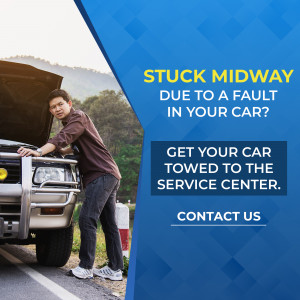 Man looking frustrated with a broken down car on the side of the road.