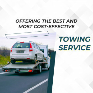 Silver car being towed on a flatbed truck